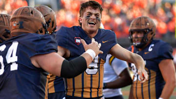 Oct 19, 2024; Champaign, Illinois, USA;  Illinois Fighting Illini quarterback Luke Altmyer (9) celebrates after scoring a touchdown against the Michigan Wolverines during the second half at Memorial Stadium. Mandatory Credit: Ron Johnson-Imagn Images