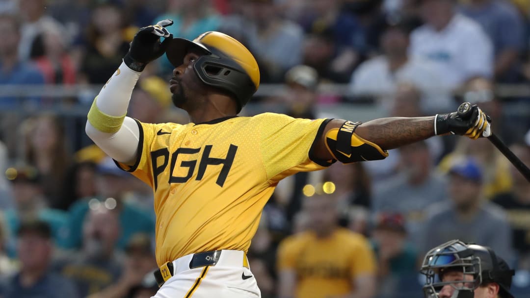 Aug 16, 2024; Pittsburgh, Pennsylvania, USA;  Pittsburgh Pirates designated hitter Andrew McCutchen (22) drives in a run with a sacrifice fly against the Seattle Mariners during the fifth inning at PNC Park. Mandatory Credit: Charles LeClaire-USA TODAY Sports