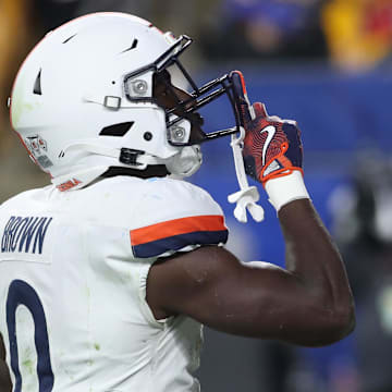 Nov 9, 2024; Pittsburgh, Pennsylvania, USA;  Virginia Cavaliers running back Xavier Brown (0) gestures to the Pittsburgh student section after scoring a touchdown against the Pittsburgh Panthers during the third quarter at Acrisure Stadium. Mandatory Credit: Charles LeClaire-Imagn Images
