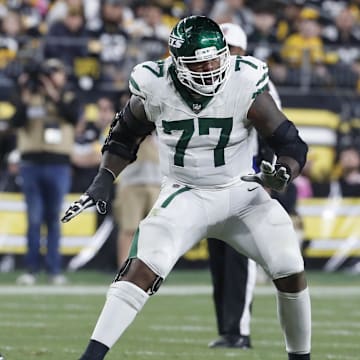 Oct 20, 2024; Pittsburgh, Pennsylvania, USA;  New York Jets offensive tackle Tyron Smith (77) blocks against Pittsburgh Steelers linebacker Alex Highsmith (56) at the line of scrimmage during the third quarter at Acrisure Stadium. Mandatory Credit: Charles LeClaire-Imagn Images