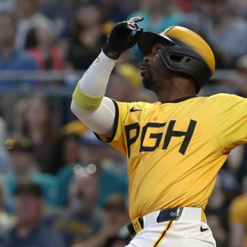 Aug 16, 2024; Pittsburgh, Pennsylvania, USA;  Pittsburgh Pirates designated hitter Andrew McCutchen (22) drives in a run with a sacrifice fly against the Seattle Mariners during the fifth inning at PNC Park. Mandatory Credit: Charles LeClaire-USA TODAY Sports