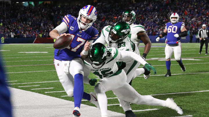 Bills quarterback Josh Allen is hit as he goes out of bounds by Jets Hamsah Nasirildeen. The Bills beat the Jets 27-10 to win the AFC east.