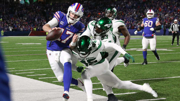 Bills quarterback Josh Allen is hit as he goes out of bounds by Jets Hamsah Nasirildeen. The Bills beat the Jets 27-10 to win the AFC east.