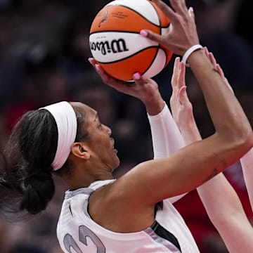 Sep 11, 2024; Indianapolis, Indiana, USA; Indiana Fever forward Katie Lou Samuelson (33) attempts to block Las Vegas Aces center A'ja Wilson (22) on Wednesday, Sept. 11, 2024, during a game between the Indiana Fever and the Las Vegas Aces at Gainbridge Fieldhouse in Indianapolis. The Aces defeated the Fever, 86-75. Mandatory Credit: Grace Smith