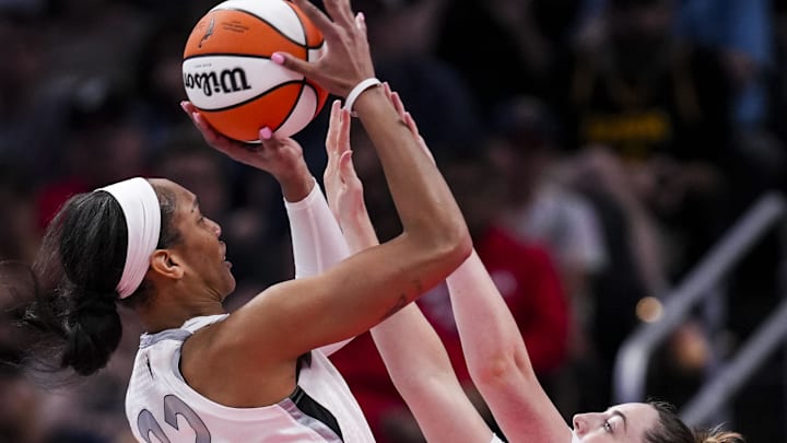 Sep 11, 2024; Indianapolis, Indiana, USA; Indiana Fever forward Katie Lou Samuelson (33) attempts to block Las Vegas Aces center A'ja Wilson (22) on Wednesday, Sept. 11, 2024, during a game between the Indiana Fever and the Las Vegas Aces at Gainbridge Fieldhouse in Indianapolis. The Aces defeated the Fever, 86-75. Mandatory Credit: Grace Smith