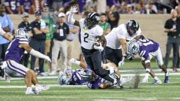 Sep 23, 2023; Manhattan, Kansas, USA; UCF Knights wide receiver Kobe Hudson (2) tries to get away from several Kansas State Wildcats defenders during the fourth quarter at Bill Snyder Family Football Stadium. Mandatory Credit: Scott Sewell-USA TODAY Sports