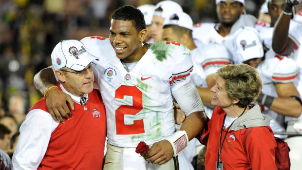 Jan 1, 2010; Pasadena, CA, USA; Ohio State Buckeyes quarterback Terrelle Pryor (2) is embraced by coach Jim Tressel (left) and Ellen Tressel (right) after the 2010 Rose Bowl against the Oregon Ducks at the Rose Bowl. Ohio State defeated Oregon 26-17. Mandatory Credit: Kirby Lee/Image of Sport-USA TODAY Sports
