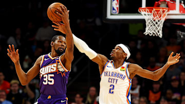 Mar 3, 2024; Phoenix, Arizona, USA; Phoenix Suns forward Kevin Durant (35) and Oklahoma City Thunder guard Shai Gilgeous-Alexander (2) go for the ball during the second quarter at Footprint Center. Mandatory Credit: Mark J. Rebilas-Imagn Images
