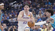 Oct 9, 2025; Oklahoma City, Oklahoma, USA; Oklahoma City Thunder guard Brooks Barnhizer (23) drives between Charlotte Hornets guard Tre Mann (23) and guard Lamelo Ball (1) during the second quarter of a game between the Charlotte Hornets and the Oklahoma City Thunder at Paycom Center. Mandatory Credit: Alonzo Adams-Imagn Images