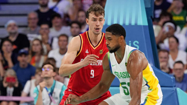 Brazil power forward Bruno Caboclo drives to the basket against Germany guard Franz Wagner in men’s basketball group B play during the Paris 2024 Olympic Summer Games at Stade Pierre-Mauroy.