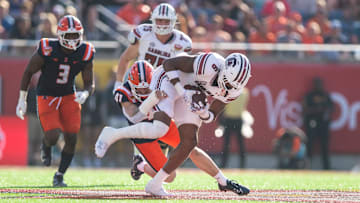 Dec 31, 2024; Orlando, FL, USA; South Carolina Gamecocks running back Dylan Stewart (6) runs the ball against Illinois Fighting Illini linebacker James Kreutz (41) in the first quarter at Camping World Stadium. Mandatory Credit: Jeremy Reper-Imagn Images