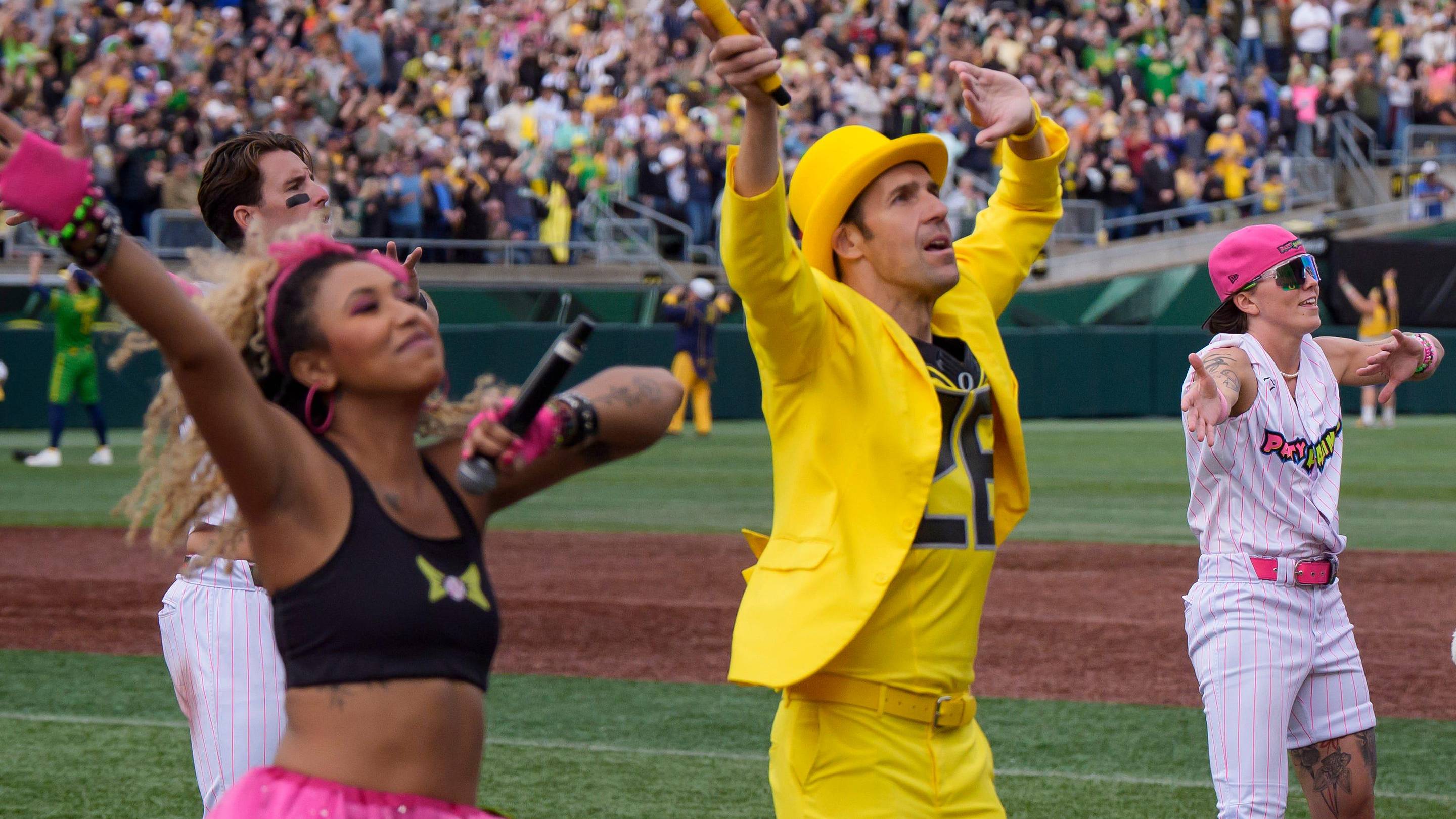 Jesse Cole, center left, and the Oregon Duck dance in matching yellow suits as the Savannah Bananas visit Autzen Stadium in Eugene, Oregon on June 27, 2026.