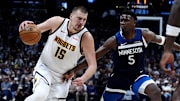 Mar 12, 2025; Denver, Colorado, USA; Minnesota Timberwolves guard Anthony Edwards (5) defends Denver Nuggets center Nikola Jokic (15) in the second half at Ball Arena. 