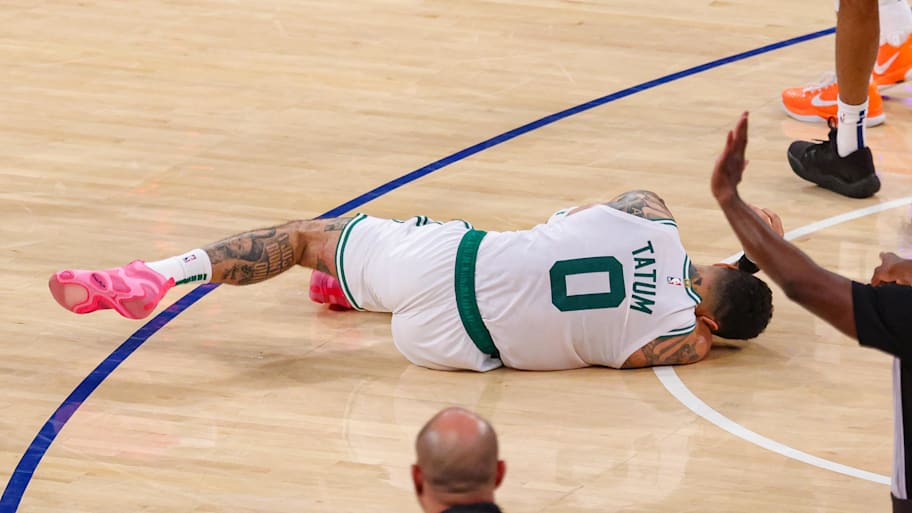 Boston Celtics forward Jayson Tatum lays on the court after suffering an injury. | Vincent Carchietta-Imagn Images