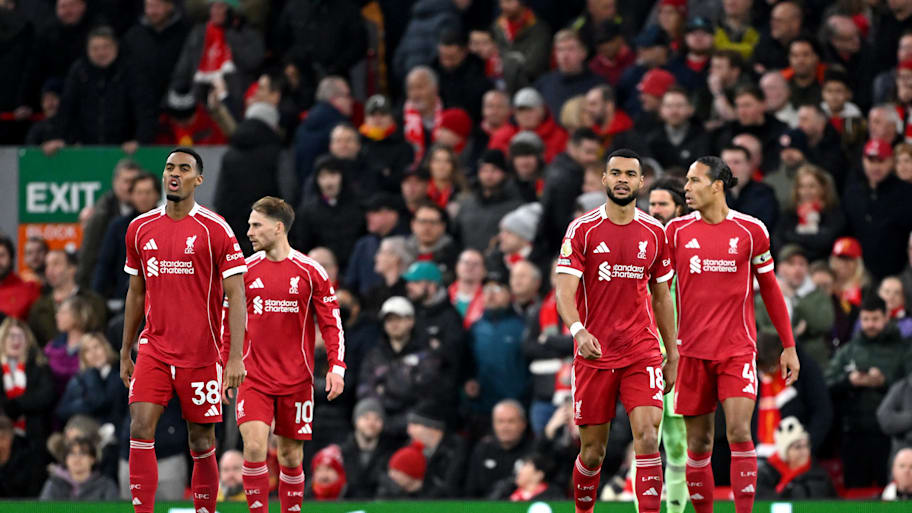 Liverpool players looking upset.