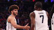 Nov 18, 2025; New York, New York, USA; Duke Blue Devils forward Cameron Boozer (12) slaps hands with d7#2 after a basket against the Kansas Jayhawks during the second half at Madison Square Garden. Mandatory Credit: Vincent Carchietta-Imagn Images
