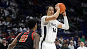 Mar 1, 2025; University Park, Pennsylvania, USA; Penn State Nittany Lions forward Yanic Konan Niederhauser (14) looks to pass the ball as Maryland Terrapins forward Julian Reese (10) defends during the first half at Bryce Jordan Center. Mandatory Credit: Matthew O'Haren-Imagn Images