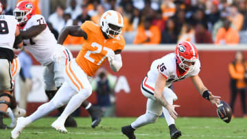 Georgia quarterback Carson Beck (15) fumbles the ball as Tennessee defensive lineman James Pearce Jr. (27) trails him, during a football game between Tennessee and Georgia at Neyland Stadium in Knoxville, Tenn., on Saturday, Nov. 18, 2023.