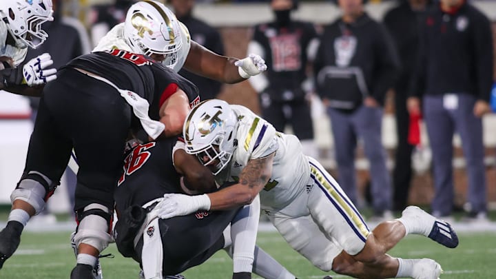 Nov 21, 2024; Atlanta, Georgia, USA; Georgia Tech Yellow Jackets linebacker Kyle Efford (44) tackles North Carolina State Wolfpack quarterback CJ Bailey (16) in the third quarter at Bobby Dodd Stadium at Hyundai Field. Mandatory Credit: Brett Davis-Imagn Images Nov 21, 2024; Atlanta, Georgia, USA; Georgia Tech Yellow Jackets linebacker Kyle Efford (44) tackles North Carolina State Wolfpack quarterback CJ Bailey (16) in the third quarter at Bobby Dodd Stadium at Hyundai Field. Mandatory Credit: Brett Davis-Imagn Images
