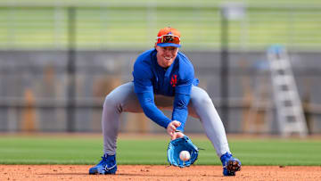 Feb 19, 2025; Port St. Lucie, FL, USA; New York Mets infielder Brett Baty (7) catches a baseball during a spring training workout at Clover Park. Mandatory Credit: Sam Navarro-Imagn Images