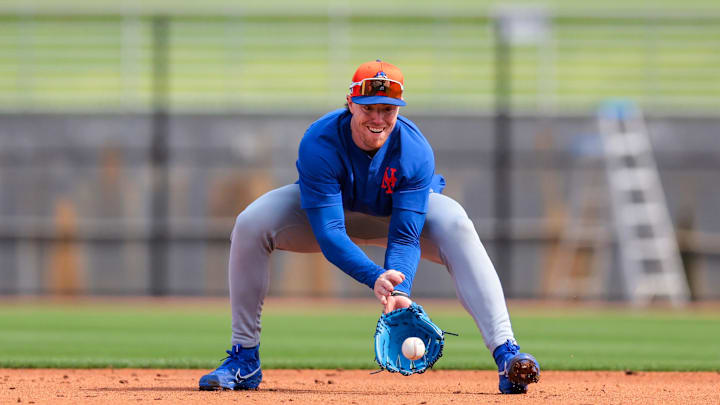 Feb 19, 2025; Port St. Lucie, FL, USA; New York Mets infielder Brett Baty (7) catches a baseball during a spring training workout at Clover Park. Mandatory Credit: Sam Navarro-Imagn Images