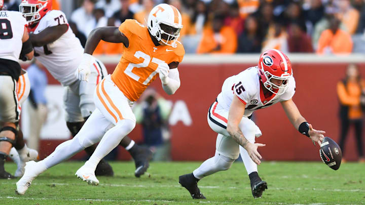 Georgia quarterback Carson Beck (15) fumbles the ball as Tennessee defensive lineman James Pearce Jr. (27) trails him, during a football game between Tennessee and Georgia at Neyland Stadium in Knoxville, Tenn., on Saturday, Nov. 18, 2023. Georgia quarterback Carson Beck (15) fumbles the ball as Tennessee defensive lineman James Pearce Jr. (27) trails him, during a football game between Tennessee and Georgia at Neyland Stadium in Knoxville, Tenn., on Saturday, Nov. 18, 2023.