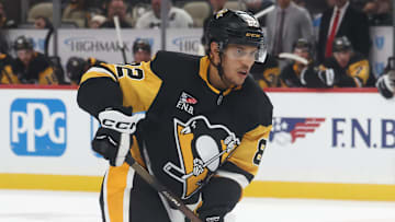 Oct 21, 2025; Pittsburgh, Pennsylvania, USA;  Pittsburgh Penguins defenseman Caleb Jones (82) handles the puck against the Vancouver Canucks during the third period at PPG Paints Arena. Mandatory Credit: Charles LeClaire-Imagn Images