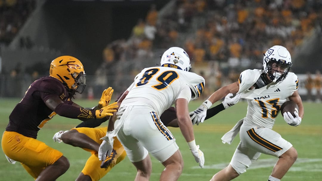 Arizona State Sun Devils defensive back Montana Warren (7) pulls on Northern Arizona Lumberjacks wide receiver Joey Stout (13) during a football game at Mountain America Stadium in Tempe on Aug. 30, 2025.