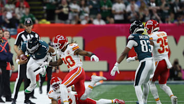 Feb 9, 2025; New Orleans, LA, USA; Philadelphia Eagles quarterback Jalen Hurts (1) leaps out of bounds while runs with the ball as Kansas City Chiefs safety Bryan Cook (6) and Chiefs safety Justin Reid (20) chase during Super Bowl LIX at Caesars Superdome. Mandatory Credit: Geoff Burke-Imagn Images