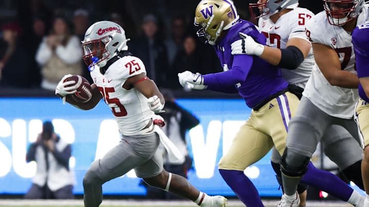 Nov 25, 2023; Seattle, Washington, USA; Washington State Cougars running back Nakia Watson (25) rushes against the Washington Huskies during the fourth quarter at Alaska Airlines Field at Husky Stadium. Mandatory Credit: Joe Nicholson-Imagn Images