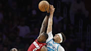 Mar 10, 2025; Miami, Florida, USA;  Charlotte Hornets forward Moussa Diabate (14) watches guard Seth Curry (30) and Miami Heat guard Terry Rozier (2) jump for a rebound during the second half at Kaseya Center. Mandatory Credit: Rhona Wise-Imagn Images