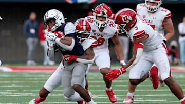 Nov 18, 2023; Tucson, Arizona, USA; Arizona Wildcats running back Rayshon Luke (21) runs the ball against Utah Utes cornerback JaTravis Broughton (4) during the second half at Arizona Stadium. 