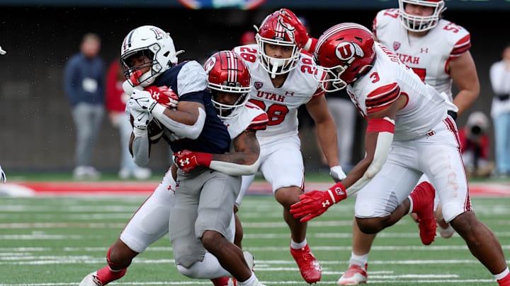 Nov 18, 2023; Tucson, Arizona, USA; Arizona Wildcats running back Rayshon Luke (21) runs the ball against Utah Utes cornerback JaTravis Broughton (4) during the second half at Arizona Stadium. 