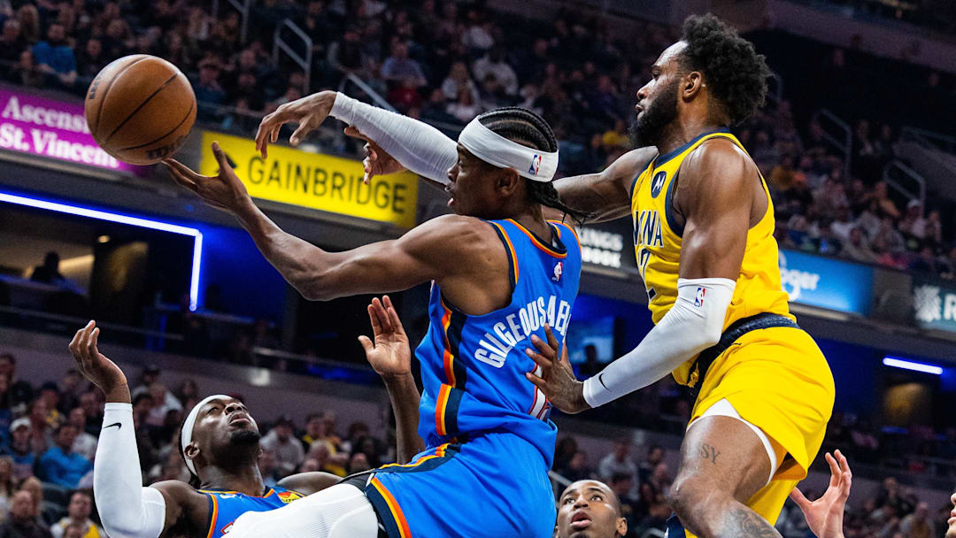 Mar 31, 2023; Indianapolis, Indiana, USA;  Oklahoma City Thunder guard Shai Gilgeous-Alexander (2) and Indiana Pacers forward Oshae Brissett (12) fight for a rebound in the second quarter at Gainbridge Fieldhouse. Mandatory Credit: Trevor Ruszkowski-Imagn Images