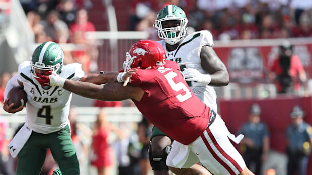 UAB Blazers quarterback Jacob Zeno (4) is tackled by Arkansas Razorbacks defensive lineman Cameron Ball 