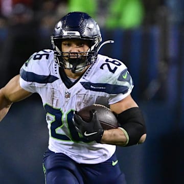 Dec 26, 2024; Chicago, Illinois, USA; Seattle Seahawks running back Zach Charbonnet (26) runs after a catch against the Chicago Bears during the fourth quarter at Soldier Field.