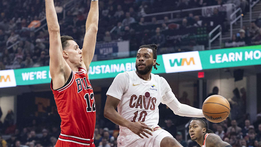 Cavaliers guard Darius Garland passes the ball past Bulls forward-center Zach Collins.