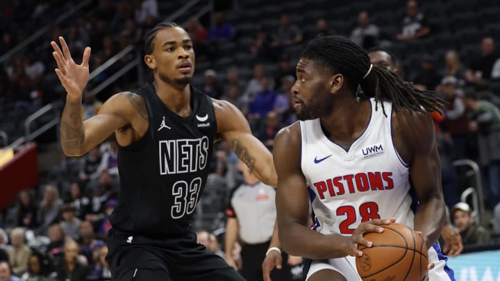 Mar 7, 2024; Detroit, Michigan, USA;  Detroit Pistons center Isaiah Stewart (28) is defended by Brooklyn Nets center Nic Claxton (33) in the first half at Little Caesars Arena. Mandatory Credit: Rick Osentoski-USA TODAY Sports