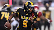 Aug 29, 2024; Little Rock, Arkansas, USA; Pine Bluff Golden Lions quarterback Mekhi Hagens (9) rushes in the second quarter against the Arkansas Razorbacks at War Memorial Stadium. Mandatory Credit: Nelson Chenault-Imagn Images