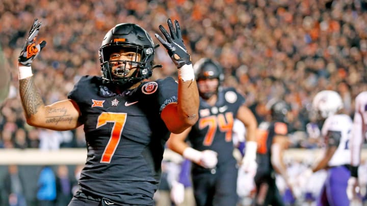 Oklahoma State's Jaylen Warren (7) celebrates a touchdown in the first quarter against TCU.

Syndication The Oklahoman