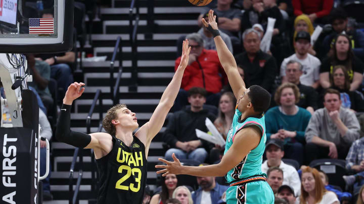 Feb 25, 2023; Salt Lake City, Utah, USA; San Antonio Spurs forward Keldon Johnson (right) shoots the ball over Utah Jazz forward Lauri Markkanen (23) in the second half at Vivint Arena. Mandatory Credit: Rob Gray-USA TODAY Sports