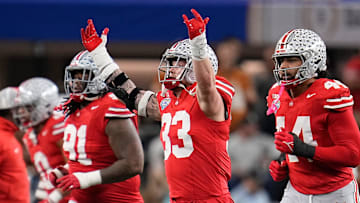 Ohio State Buckeyes defensive end Jack Sawyer (33) celebrates a fourth down stop during the first half of the Cotton Bowl Classic College Football Playoff semifinal game against the Texas Longhorns at AT&T Stadium in Arlington, Texas on Jan. 10, 2025.
