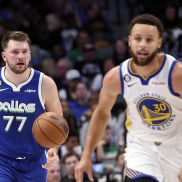 Nov 29, 2022; Dallas, Texas, USA;  Dallas Mavericks guard Luka Doncic (77) dribbles as Golden State Warriors guard Stephen Curry (30) runs upcourt during the second half at American Airlines Center. Mandatory Credit: Kevin Jairaj-USA TODAY Sports