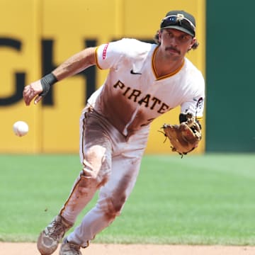 Jun 29, 2025; Pittsburgh, Pennsylvania, USA;  Pittsburgh Pirates second baseman Adam Frazier (26) fields a ground ball for an out against New York Mets third baseman Brett Baty (not pictured) during the fifth inning at PNC Park. Mandatory Credit: Charles LeClaire-Imagn Images