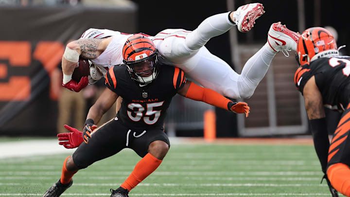 Dec 28, 2025; Cincinnati, Ohio, USA; Cincinnati Bengals cornerback Jalen Davis (35) tackles Arizona Cardinals tight end Trey McBride (85) during the second half at Paycor Stadium. Mandatory Credit: Joseph Maiorana-Imagn Images