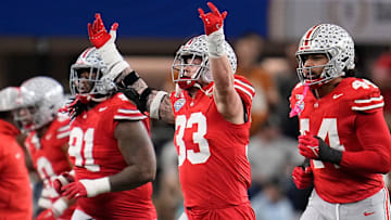 Ohio State Buckeyes defensive end Jack Sawyer (33) celebrates a fourth down stop during the first half of the Cotton Bowl Classic College Football Playoff semifinal game against the Texas Longhorns at AT&T Stadium in Arlington, Texas on Jan. 10, 2025.