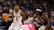 Nov 7, 2025; Los Angeles, California, USA;  UCLA Bruins guard Donovan Dent (2) drives to the basket against Pepperdine Waves forward Javon Cooley (23) during the second half at Pauley Pavilion presented by Wescom Financial. Mandatory Credit: Kiyoshi Mio-Imagn Images