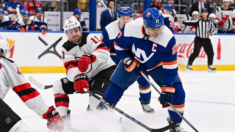 Mar 24, 2024; Elmont, New York, USA;  New Jersey Devils center Chris Tierney (11) defends against