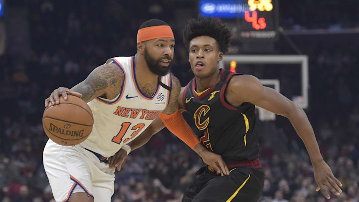 Jan 20, 2020; Cleveland, Ohio, USA; New York Knicks forward Marcus Morris Sr. (13) drives against Cleveland Cavaliers guard Collin Sexton (2) in the second quarter at Rocket Mortgage FieldHouse. Mandatory Credit: David Richard-Imagn Images