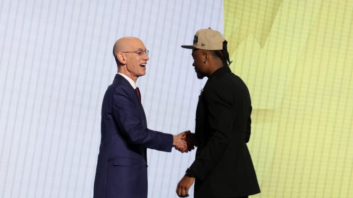 Jun 26, 2024; Brooklyn, NY, USA; Isaiah Collier shakes hands with NBA commissioner Adam Silver after being selected in the first round by the Utah Jazz in the 2024 NBA Draft at Barclays Center. Mandatory Credit: Brad Penner-USA TODAY Sports